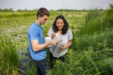 Water samples taken by a male animal biology graduate researcher and female undergraduate researcher.